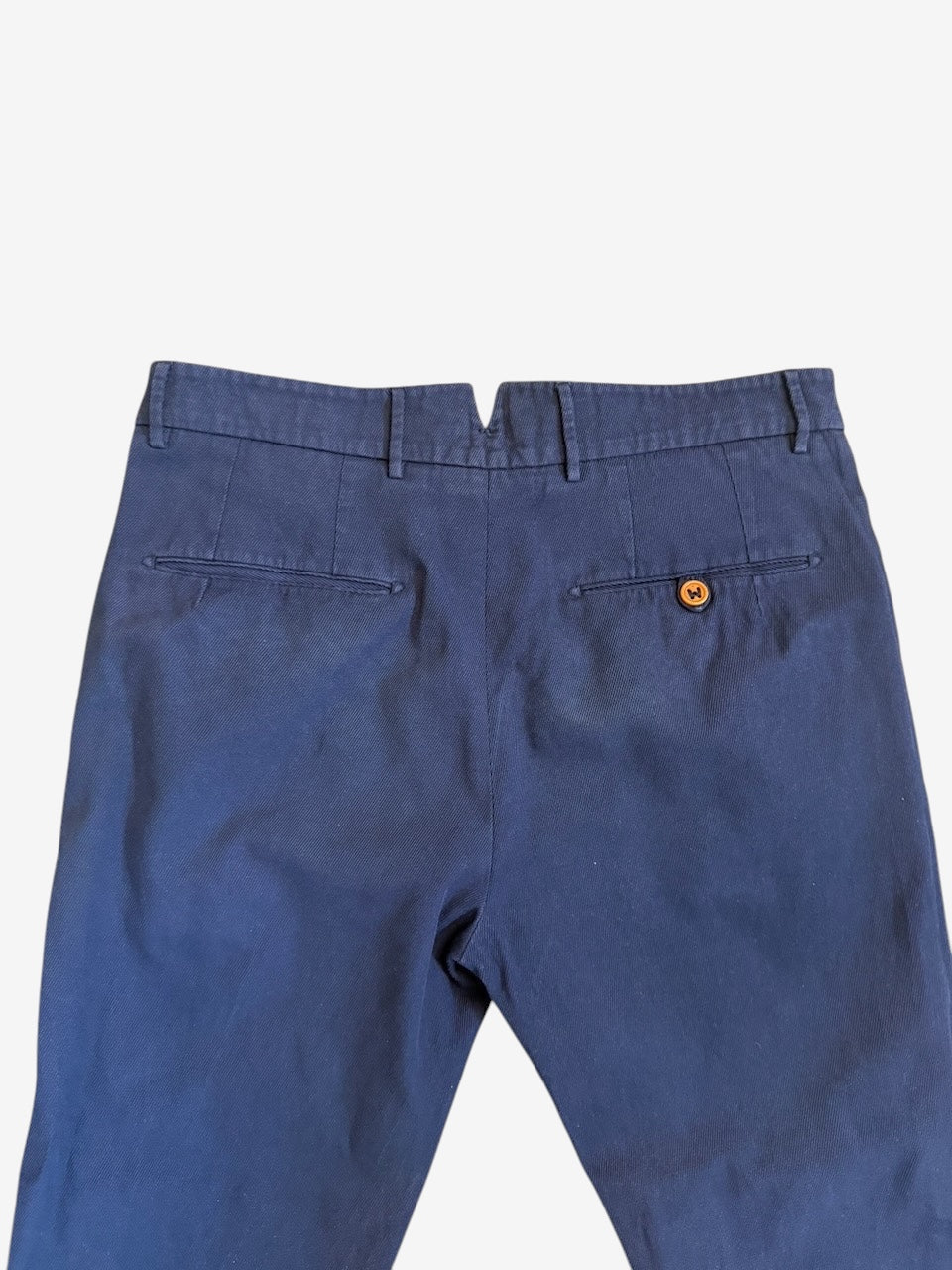 Nordic Jeans Co. BERWICH navy cotton chino trousers featuring a back view with welt pockets and a button detail.
