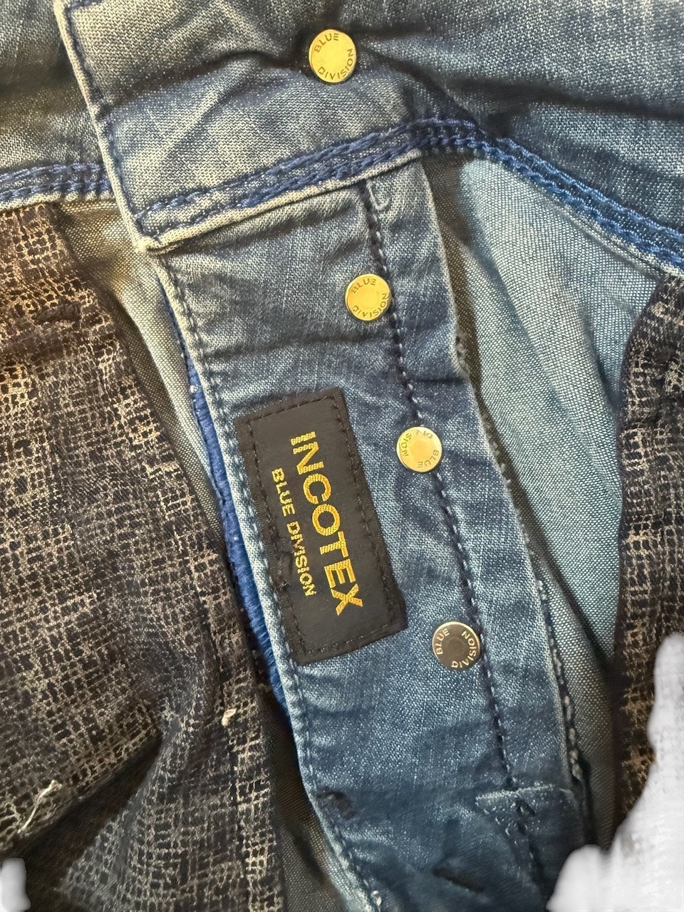 Nordic Jeans Co. Incotex Blue Division light-wash denim jeans featuring branded hardware and patterned pocket lining