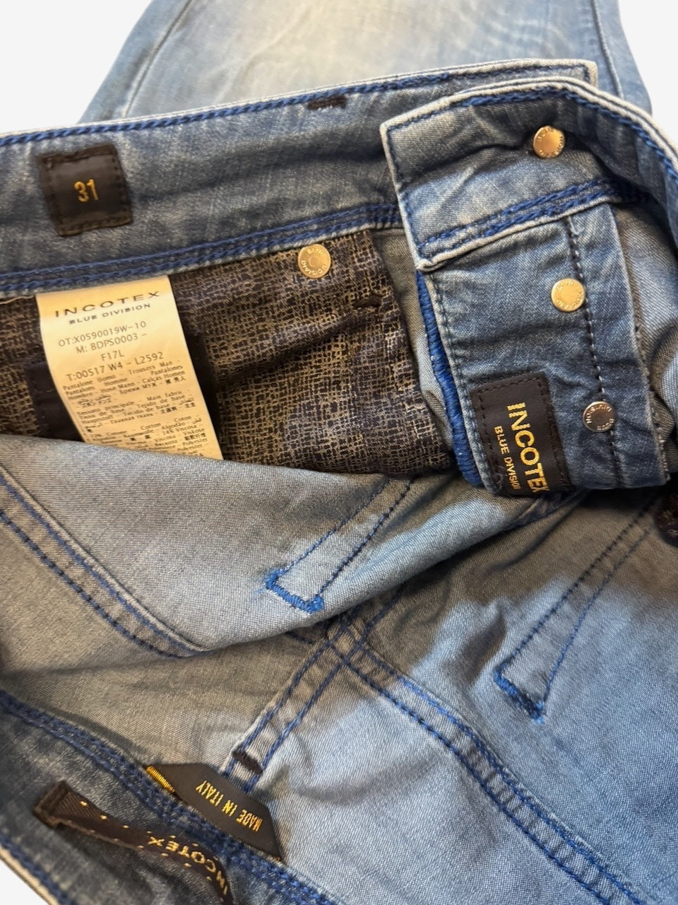 Nordic Jeans Co. Incotex Blue Division light-wash denim jeans showing interior patterned pocket lining and branding.