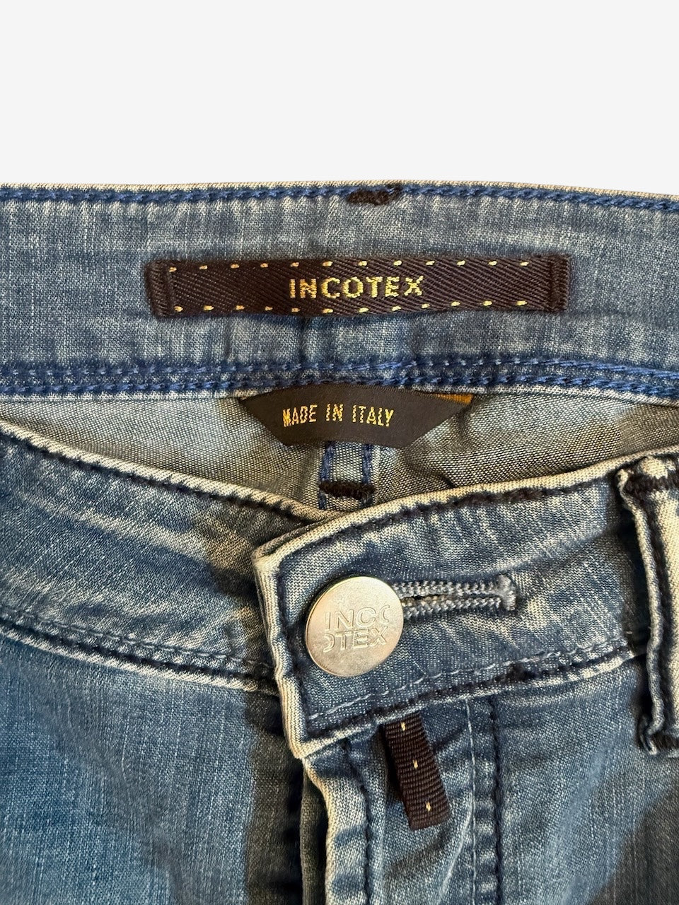 Nordic Jeans Co. Incotex Blue Division light-wash denim jeans featuring branded button and Made in Italy label.