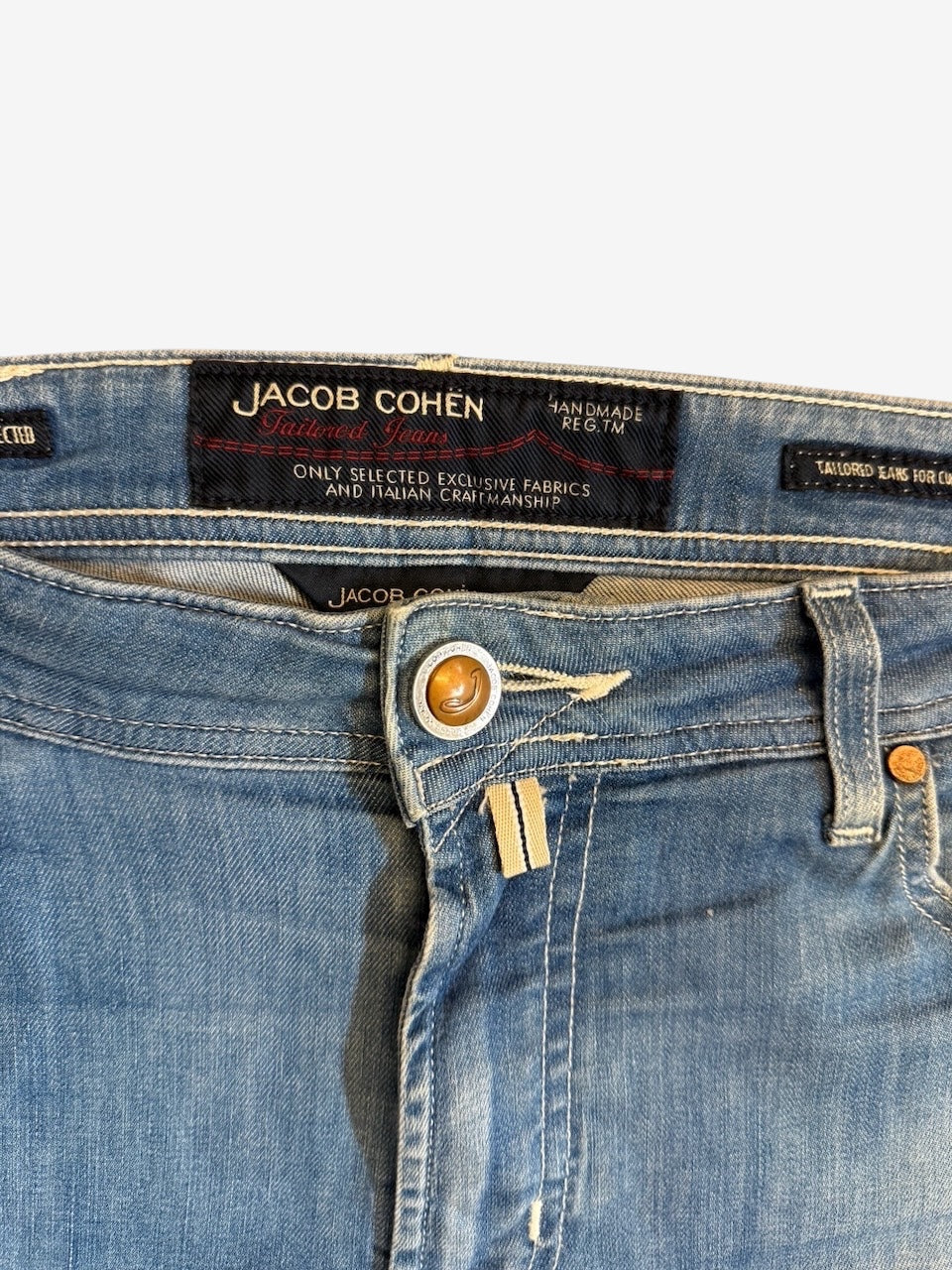 Nordic Jeans Co. Jacob Cohen light wash denim jeans featuring a branded leather back patch and signature button.
