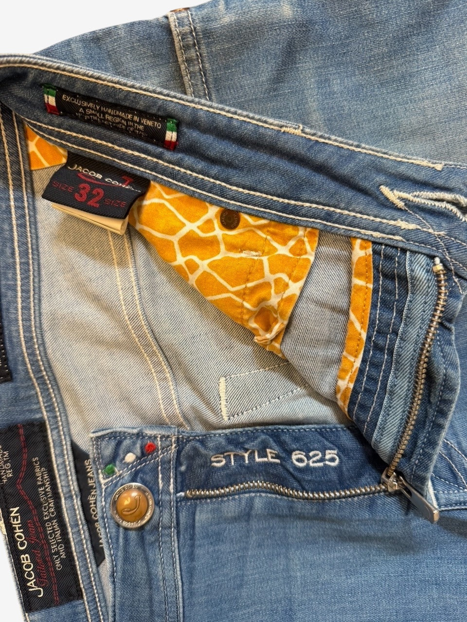 Nordic Jeans Co. Jacob Cohen light wash denim jeans featuring signature branded hardware and giraffe print pocket lining