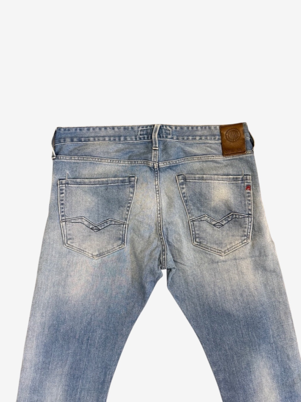 Nordic Jeans Co. Replay Waitom light-wash denim jeans featuring a brown leather back patch and signature stitching.