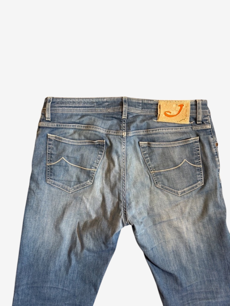 Nordic Jeans Co. light-wash denim jeans featuring back pockets with stitching and a signature leather patch