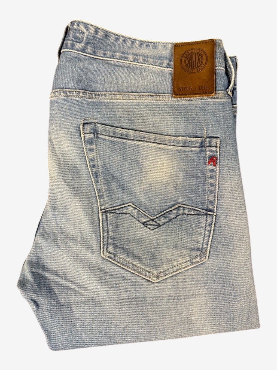 Nordic Jeans Co. Replay Waitom light-wash denim jeans with a brown leather back patch and signature pocket stitching.