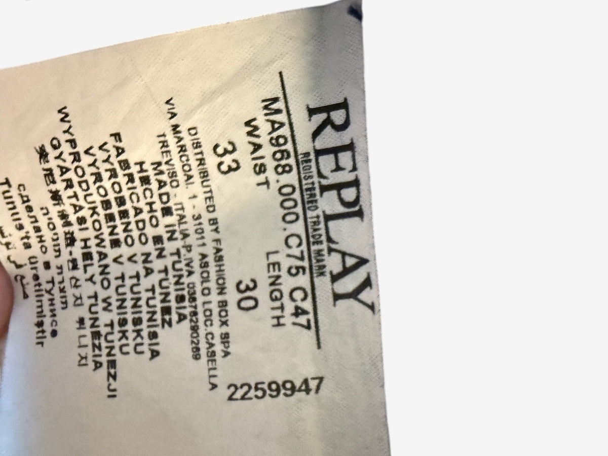 Nordic Jeans Co. REPLAY Joe slim fit denim jeans internal care label showing size 33 waist and 30 length
