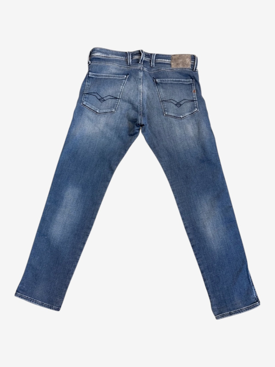 Nordic Jeans Co. REPLAY Joe slim fit denim jeans in a medium blue wash with back pocket stitching and leather patch.