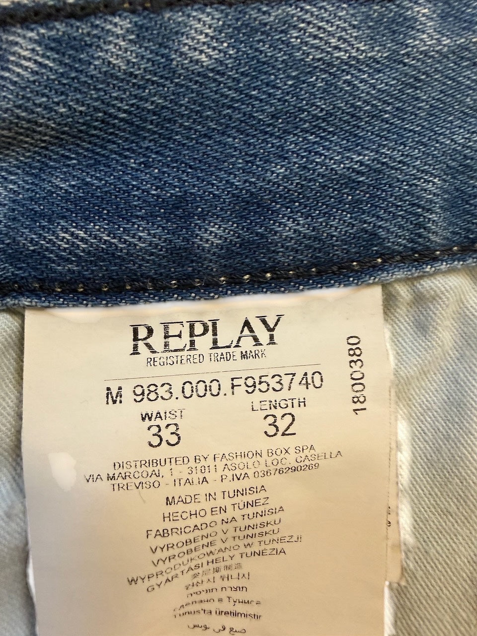 Nordic Jeans Co. Replay Waitom denim jeans inner label showing size 33 waist and 32 length in light wash cotton blend