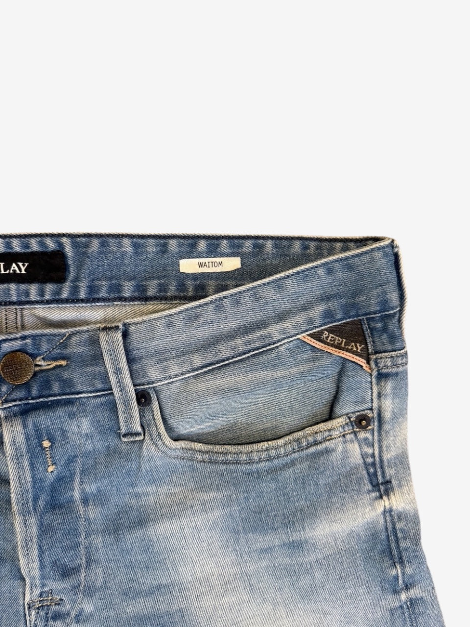 Nordic Jeans Co. Replay Waitom light-wash denim jeans featuring a coin pocket with embroidered logo and metal button.